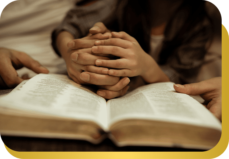 Family praying together with Bible