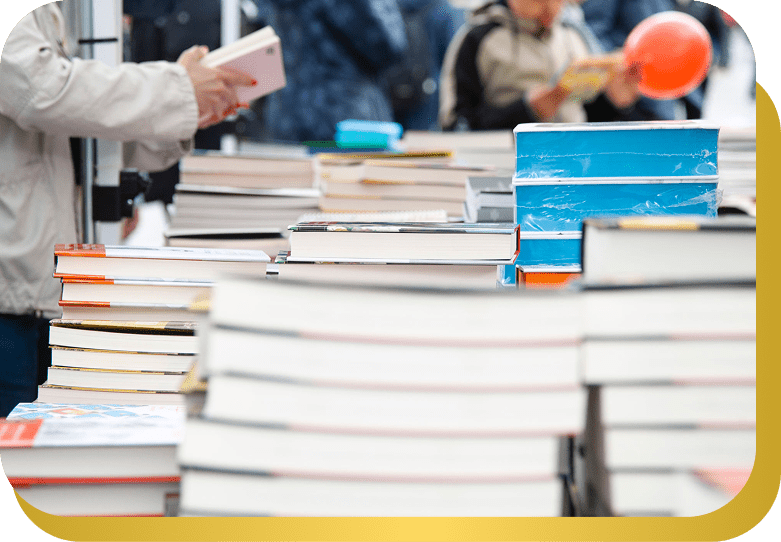 Stacked books at outdoor market