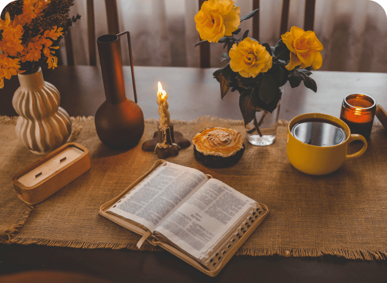 Candlelit table with coffee and pastry
