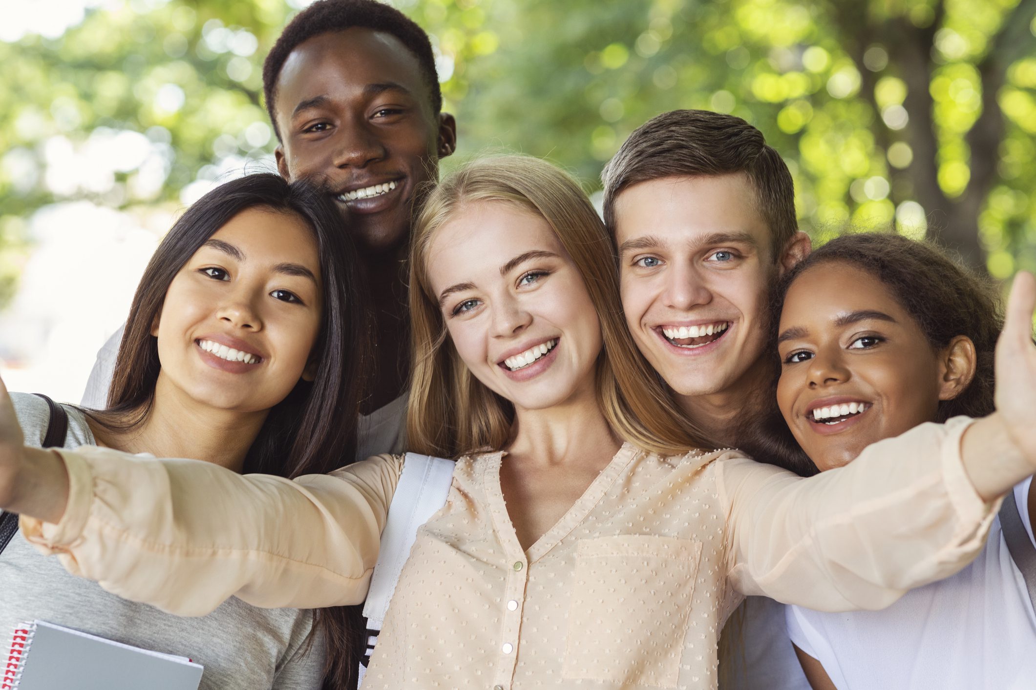 Happy teen international friends taking selfie while walking in summer park, happy memories concept